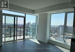 Kitchener condo for rent - A room with a view of the cityscape through large windows.