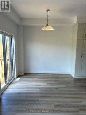 Brant (Paris) townhouse for rent - A room with wooden flooring and a hanging light fixture.