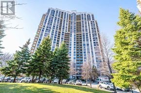 Toronto (West Humber-Clairville) condo for rent - A tall residential building with a parking lot in front.