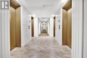Toronto (West Humber-Clairville) condo for rent - A long hallway with white walls and marble tiles.