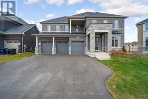 Adjala-Tosorontio (Colgan) apartment for rent - A large, modern house with a grey driveway and a sign that reads RE/MAX REALTY SPECIALISTS INC., Brokerage.