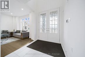 Adjala-Tosorontio (Colgan) apartment for rent - A white interior with a glass door and a black mat on the floor.
