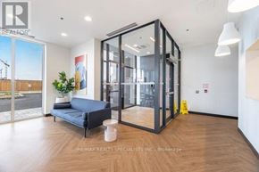 Kitchener condo for rent - A room with a blue sofa and a glass door.