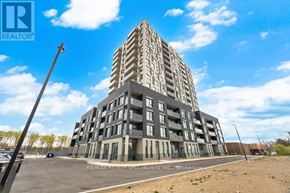 Kitchener condo for rent - A modern multi-story building with a parking lot in front.