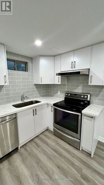 New Tecumseth (Tottenham) apartment for rent - A modern kitchen with white cabinets and stainless steel appliances.