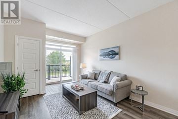 Milton (Wi Willmott) condo for rent - A living room with a grey couch and a coffee table.