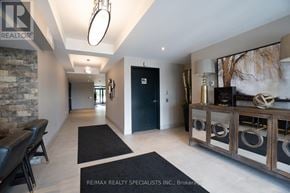 Milton (Wi Willmott) condo for rent - A hallway with a stone wall and a black door.