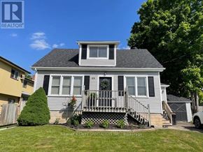 Centre Wellington (Fergus) apartment for rent - A house with a grey roof and a white fence.