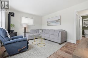 Centre Wellington (Fergus) apartment for rent - A living room with a grey couch, a blue armchair, and a coffee table.