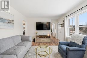 Centre Wellington (Fergus) apartment for rent - A living room with a grey couch, a blue armchair, and a coffee table.