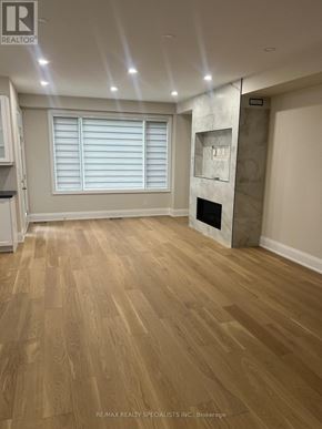 Mississauga (Lakeview) apartment for rent - A room with wooden flooring and a fireplace.