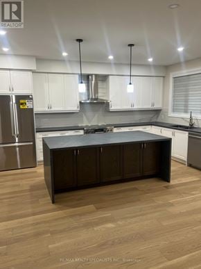 Mississauga (Lakeview) apartment for rent - A modern kitchen with a center island and stainless steel appliances.