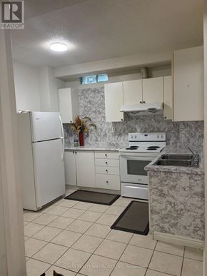 Mississauga (Meadowvale) apartment for rent - A kitchen with a refrigerator, stove, and sink.