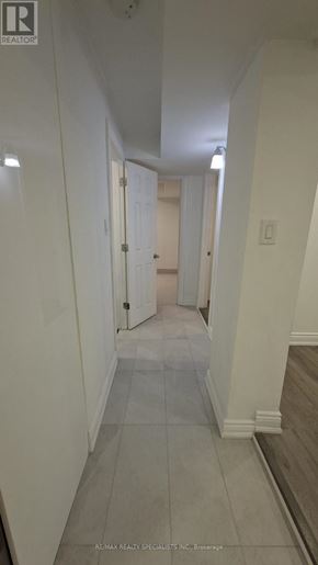 Oshawa (Vanier) apartment for rent - A long hallway with doors at the end.