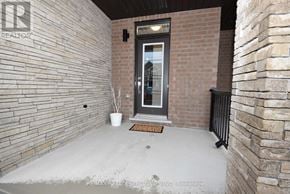 Thorold (Rolling Meadows) townhouse for rent - A room with a brick wall and a door.