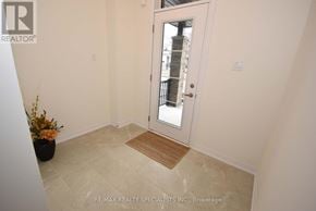 Thorold (Rolling Meadows) townhouse for rent - A hallway with a door leading to a balcony.