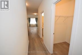 Thorold (Rolling Meadows) townhouse for rent - A hallway with a white wall and a doorway leading to another room.