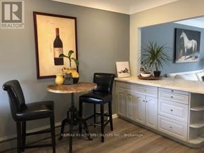 Burlington (Brant) multi-family for rent - A dining area with a wine bottle on the table.