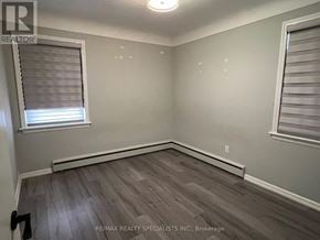 Burlington (Brant) multi-family for rent - A room with a window and wooden flooring.