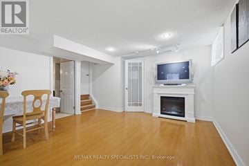 Mississauga (Lakeview) apartment for rent - A living room with a wooden floor and a television on a stand.