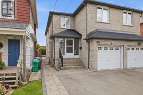 Mississauga (Lakeview) apartment for rent - A house with a blue door and a sign that says RE/MAX Realty Specialists Inc. Brokerage.