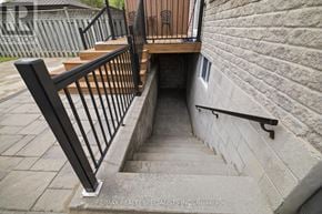 Mississauga (Lakeview) apartment for rent - A staircase with a metal railing and wooden steps leading down to a basement.