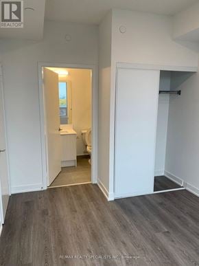 Brampton (Fletcher's Creek South) condo for rent - A room with a white door and a grey floor.