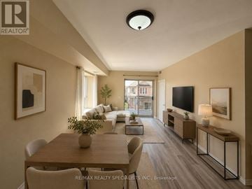 Mississauga (East Credit) condo for rent - A well-lit, modern living room with a dining table and chairs.