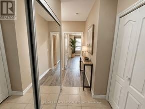 Mississauga (East Credit) condo for rent - A hallway with a table and chairs in the middle.
