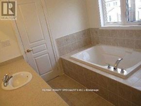 Brampton (Bram East) apartment for rent - A bathroom with a tub, sink and a window.