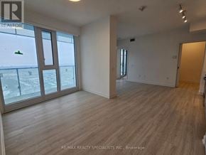 Mississauga (City Centre) condo for rent - A room with wooden flooring and a view of a snowy landscape through the windows.