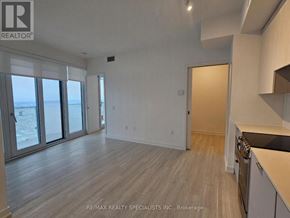 Mississauga (City Centre) condo for rent - A spacious room with a view of the ocean through the windows.