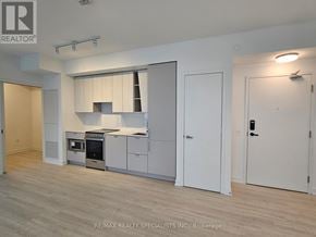 Mississauga (City Centre) condo for rent - A modern kitchen with white cabinets and a stainless steel oven.