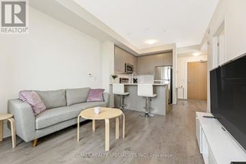 Milton (Fo Ford) condo for rent - A living room with a grey couch and a white coffee table.