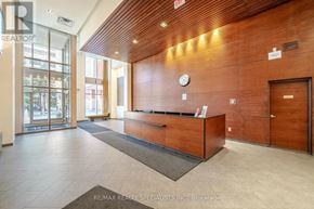 Mississauga (City Centre) condo for rent - A reception area with a wooden ceiling and a glass door.