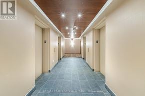Mississauga (City Centre) condo for rent - A long hallway with doors on both sides and a tiled floor.
