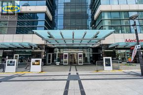 Toronto (Bay Street Corridor) condo for rent - The entrance to a building with a glass facade and a sign that reads "Adena".