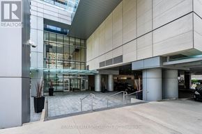 Toronto (Bay Street Corridor) condo for rent - The image shows the front of a building with a glass entrance and a sign that reads "RE/MAX REALTY SPECIALISTS INC Brokerage".