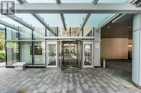 Toronto (Bay Street Corridor) condo for rent - The image shows a glass entrance to a building with a sign that reads RE/MAX Realty Specialists Inc Brokerage.