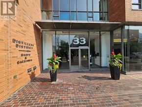 Toronto (Waterfront Communities) condo for rent - The front of a building with a glass door and a sign that reads "33".