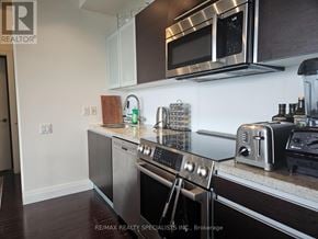 Toronto (Waterfront Communities) condo for rent - A modern kitchen with stainless steel appliances and a microwave above the oven.