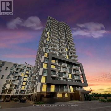 Oakville (Jm Joshua Meadows) condo for rent - A tall residential building with balconies and multiple floors is depicted.