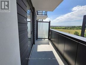 Oakville (Jm Joshua Meadows) condo for rent - A balcony with a glass door leading to a view of the countryside.