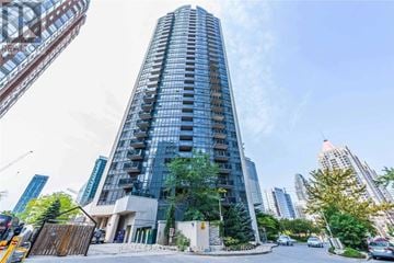 Mississauga (City Centre) condo for rent - A tall building with many windows is the main focus of the image.
