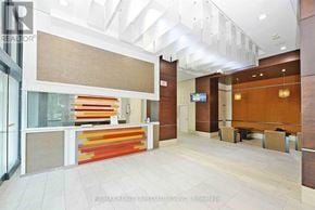 Mississauga (City Centre) condo for rent - A hallway with a glass wall and a wooden wall.