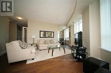 Mississauga (City Centre) condo for rent - A living room with a white couch and a black coffee table.