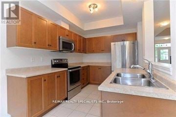 Grimsby (Grimsby Beach) townhouse for rent - A kitchen with wooden cabinets and a stainless steel refrigerator.