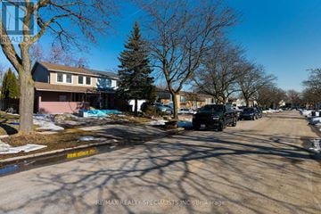 Mississauga (Meadowvale) apartment for rent - A street view with cars parked on the side and a building in the background.