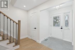 Mississauga (Meadowvale) apartment for rent - A white door with a glass window is in a room with a wooden floor.