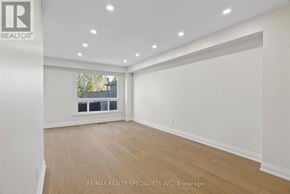 Mississauga (Meadowvale) apartment for rent - A spacious room with wooden flooring and white walls, with a window overlooking a fence.